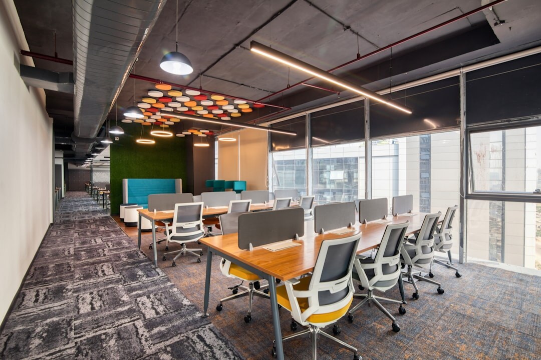 Bright editorial office with bookshelves and large windows